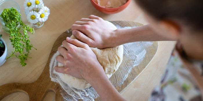 arial shot of a person kneading bread in a kitchen