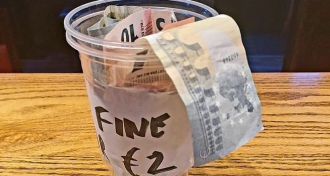 photo of plastic cup with money coming out of it