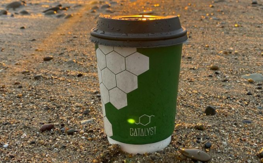 catalyst coffee cup on beach