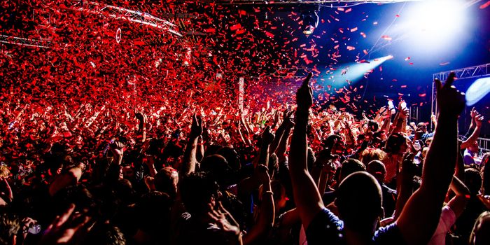 Interior of a nightclub, red confetti falling from the sky
