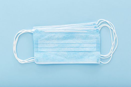 surgical face mask on blue background