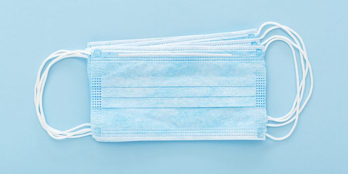 surgical face mask on blue background