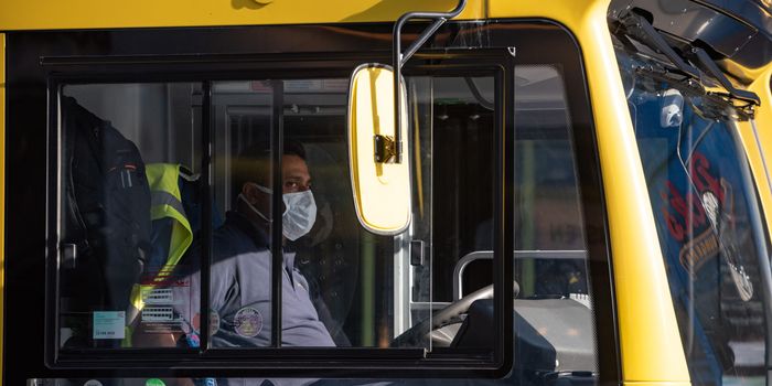 Man driving a Dublin Bus, wearing a mask