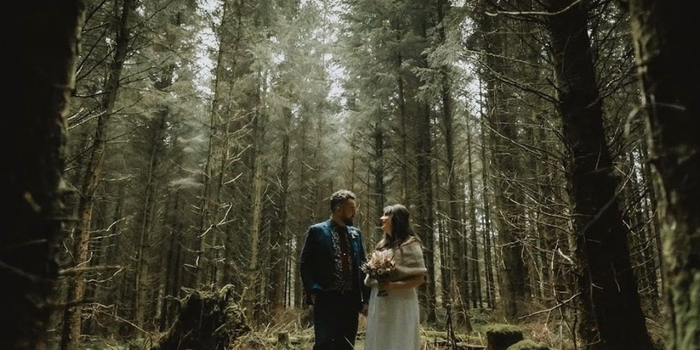 bride and groom in a forest on their wedding day