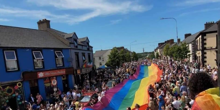 Huge rainbow flag being carried by a crows through the town of Buncrana for Donegal Pride