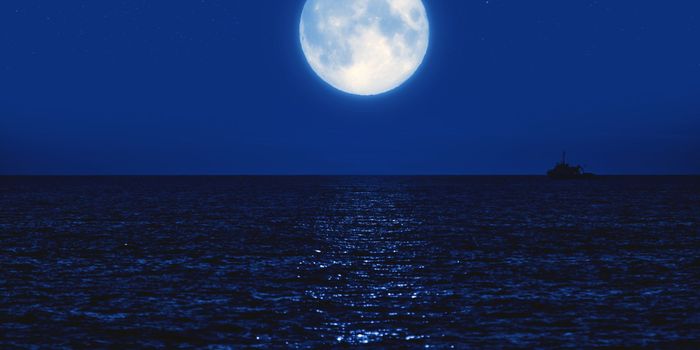 full moon at sea, reflecting on the water