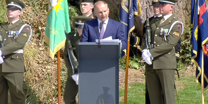 Micheal Martin giving a speech wit defence soldiers in the background