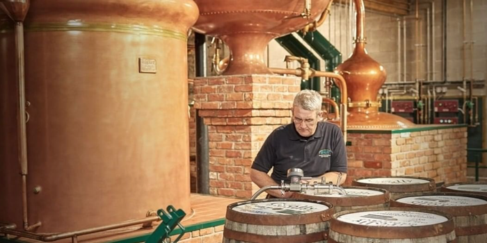 man working at a whiskey distillery