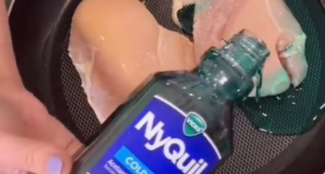 overhead shot of someone pouring NyQuil cough medicine over chicken breasts