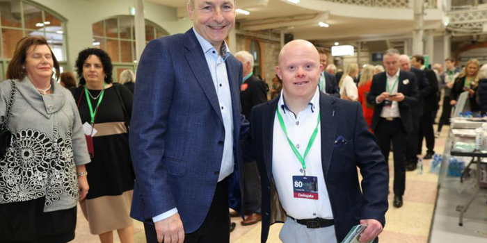 Fintan Bray posing for a picture beside taoiseach Micheál Martin at a political event