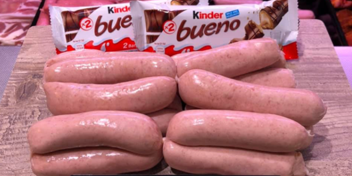 sausages on display at a butchers, with two kinder buenos behind them