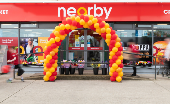 exterior of nearby store in creeslough with yellow and red balloons around the door