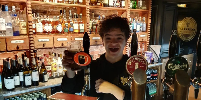 stranger things actor Gaten Matarazzo pulling a pint of guinness in a kerry pub