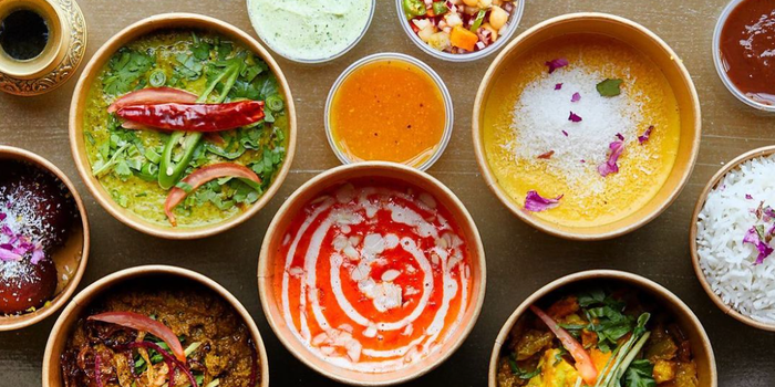 selection of curries, rices and sundries in takeaway bowls from daata