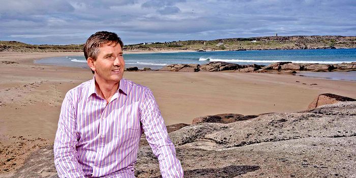 daniel o'donnell looking out into the distanceon a beach