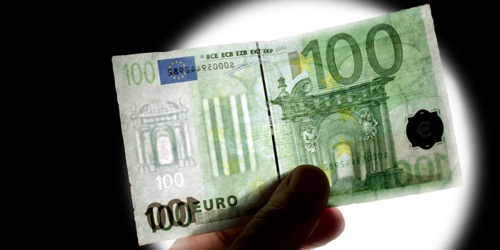 counterfeit euro note being held up against the light