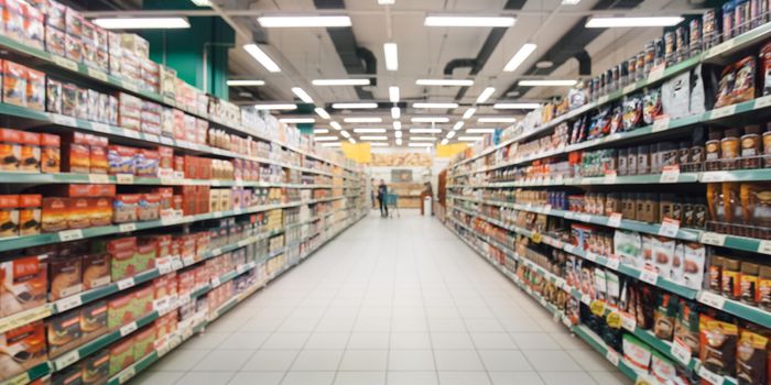 a supermarket aisle with shelves stocked with food on either side