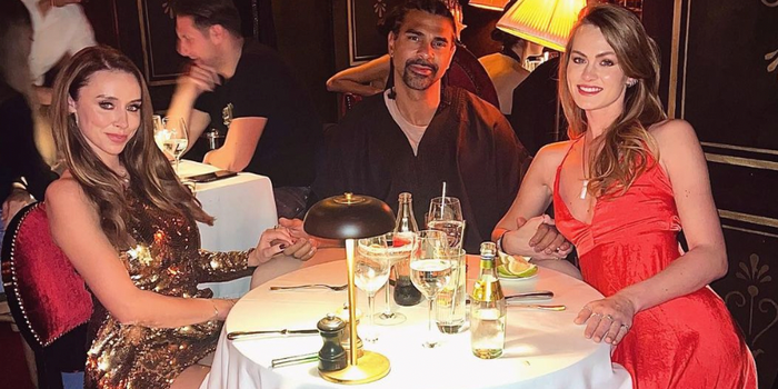 Una Healy, Sian Osbourne and David Haye sitting at a table in a restaurant holding hands