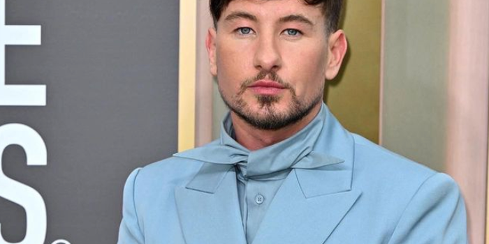 barry keoghan in a blue suit on a red carpet