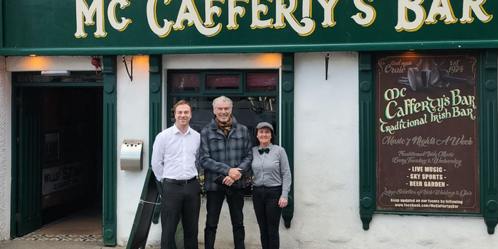 Pierce Brosnan posing for a picture with staff outside McCafferty's Bar in Donegal